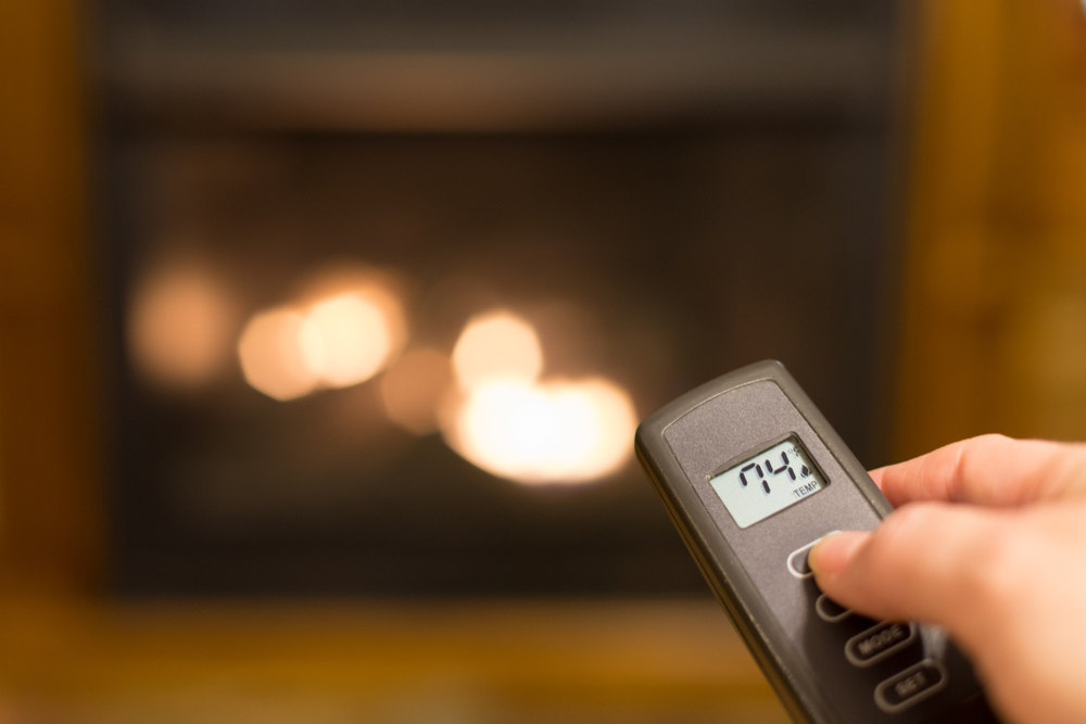 a person using a fireplace remote control 