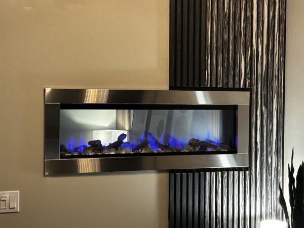 see through electric fireplace with a stainless steel frame and dark gray and marble colored acoustic wall panels