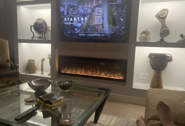 electric fireplace in built in media wall with large tv above