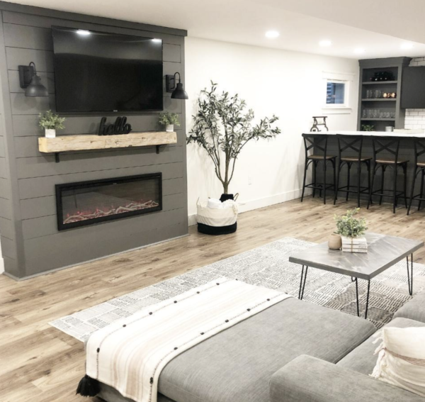 modern living room with electric fireplace in media center with shiplap surround