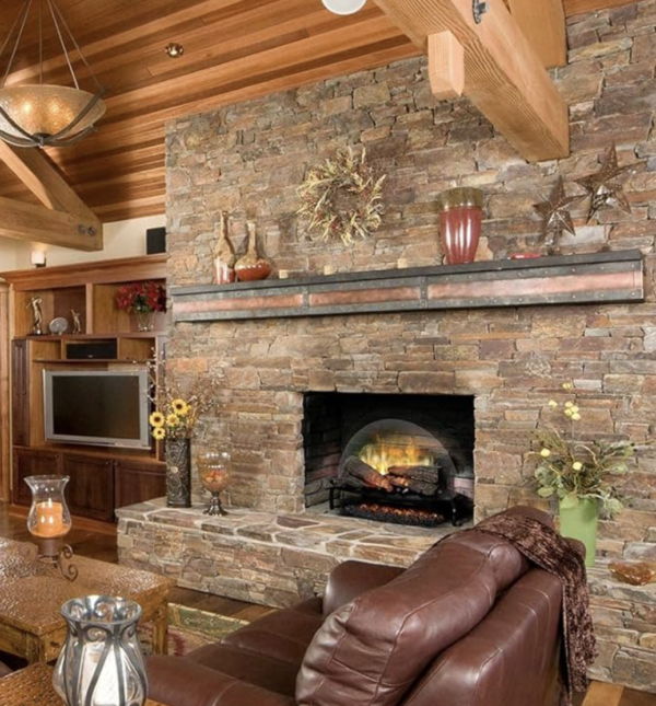 electric logs in fireplace with masonry surround